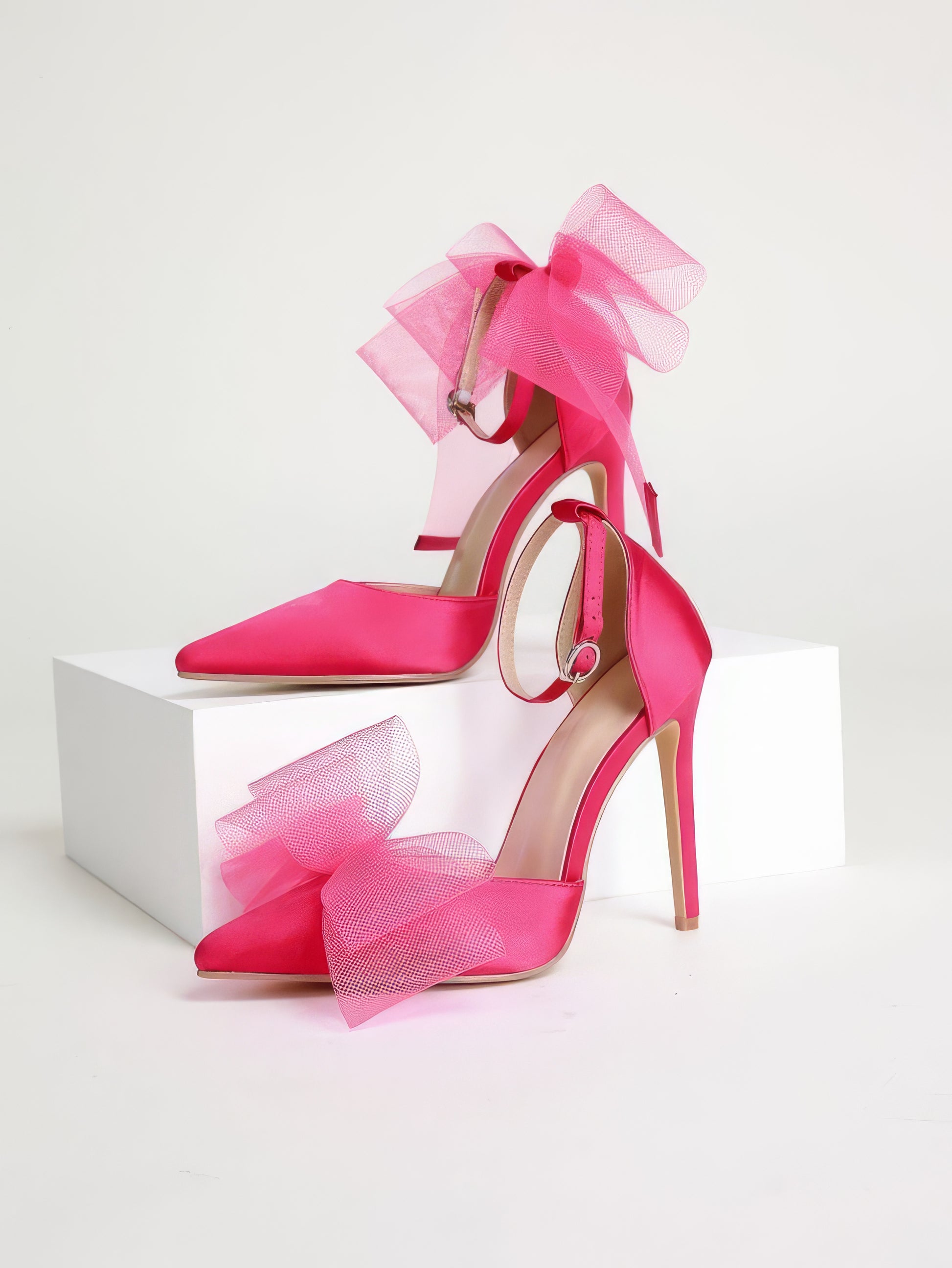Pink asymmetrical mesh heels with bow 

